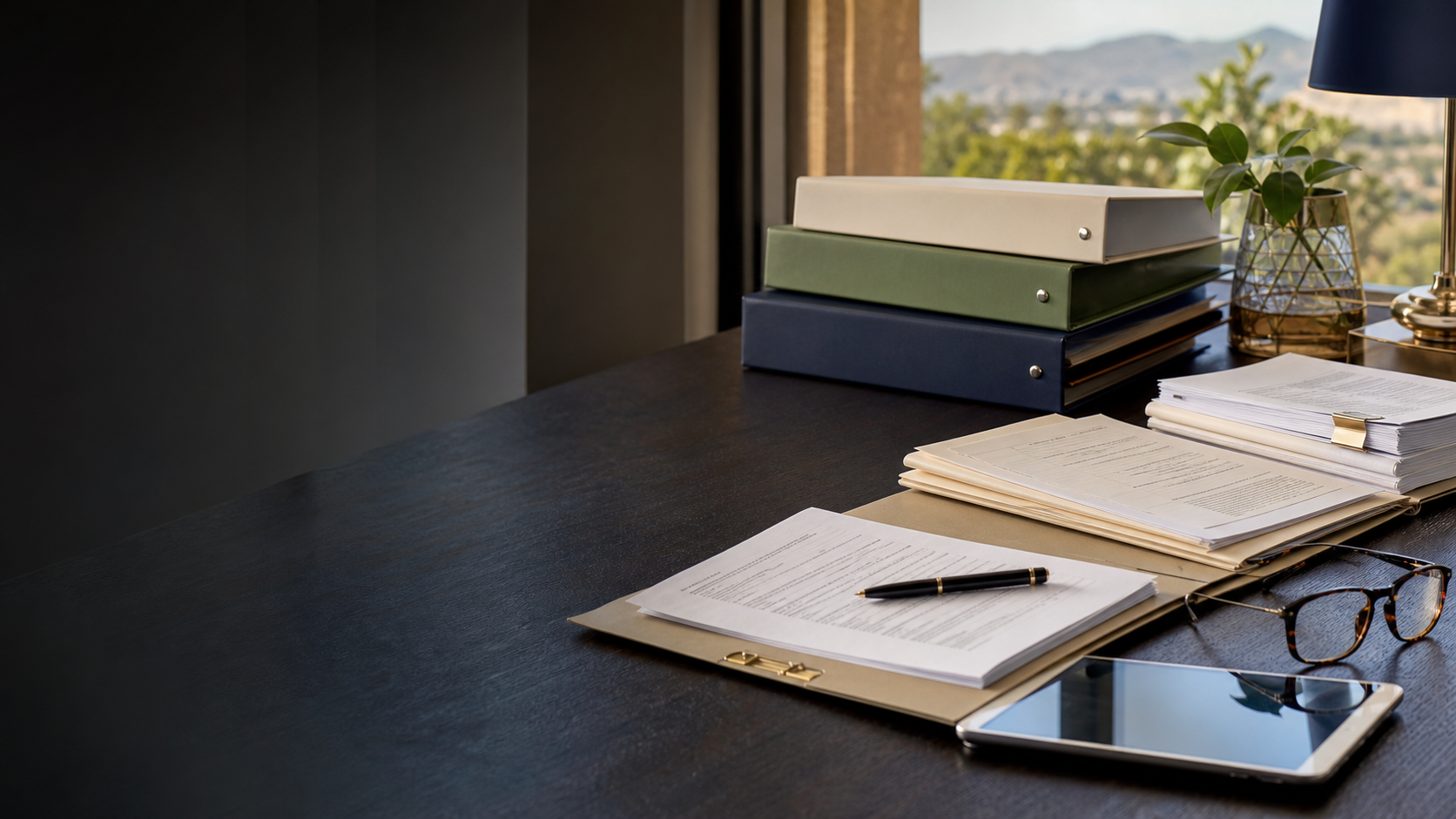 Organised statutory documents and insurance resources on an office desk